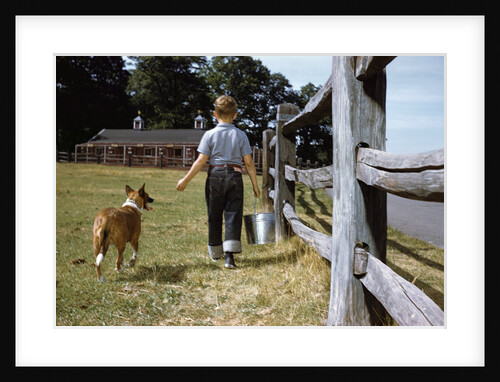 Boy and His Dog Walking Along a Fence by Anonymous