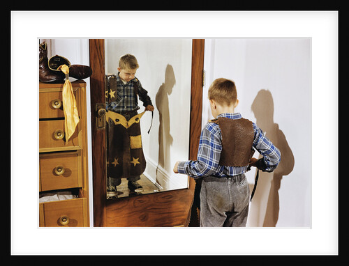 Boy Trying on Cowboy Duds by Anonymous