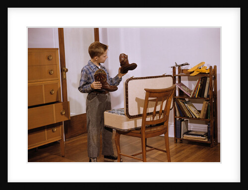 Boy Looking at Cowboy Boots by Anonymous