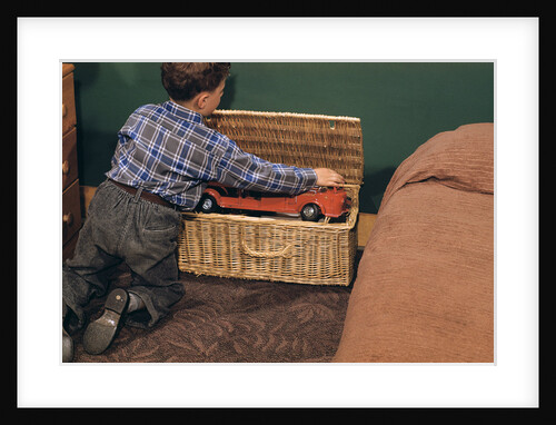 Boy Removing Fire Engine from Toy Chest by Anonymous