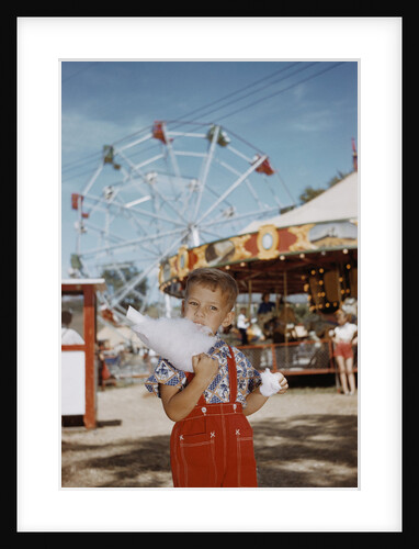 Boy Eating Cotton Candy at Fair by Anonymous