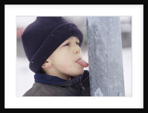 Boy Putting Tongue to Frozen Pole by Anonymous