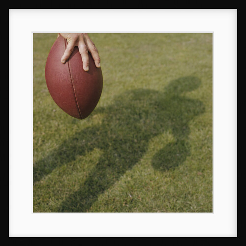 Shadow of Football Player Holding Football by Anonymous