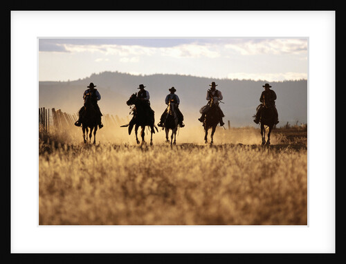 Cowboys Galloping Horses in Field by Anonymous
