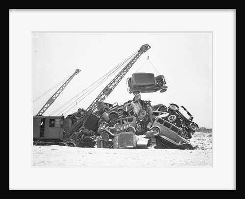 Crane Stacking Up Old Cars to be Burned in a Bonfire by Anonymous