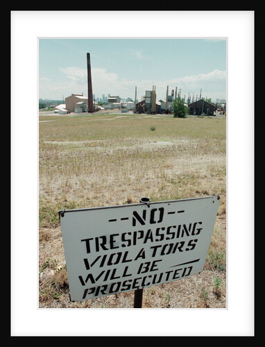 No Trespassing Sign In Field By Factory by Anonymous
