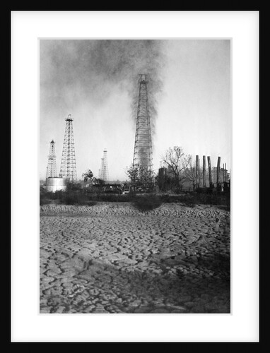 Oil Derrick with Smoke and Oil Shooting Upwards by Anonymous