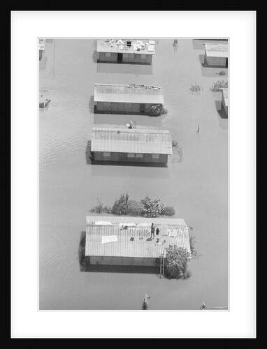 Aerial View Of Man On Roof In Flood by Anonymous