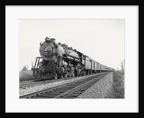 Locomotive Train Moving Down Tracks by Anonymous