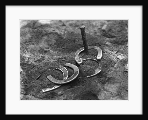 Horseshoes Around Pole by Anonymous