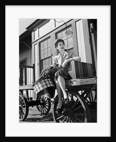 Woman Sitting on Luggage Trolley by Anonymous