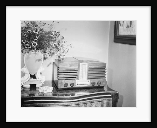 Table Radio Placed Next To Vase by Anonymous