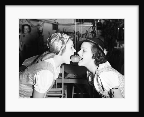 Girls Biting into Hanging Apple by Anonymous