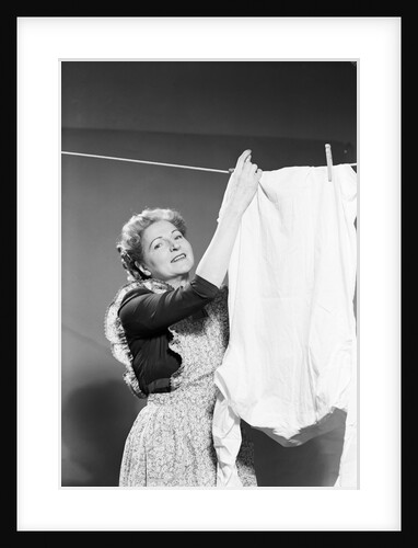 Woman Hanging Laundry by Anonymous