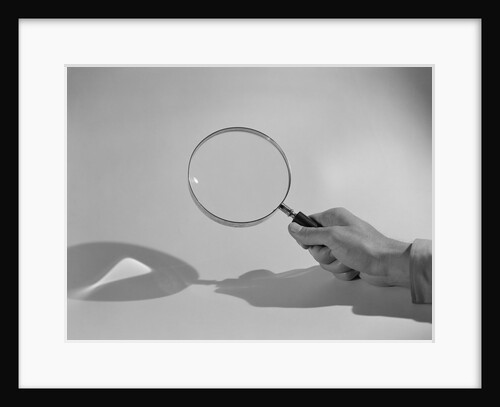 Hand Holding a Magnifying Glass by Anonymous