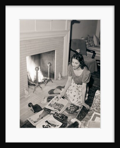 Young Woman Looking at Magazines by Anonymous