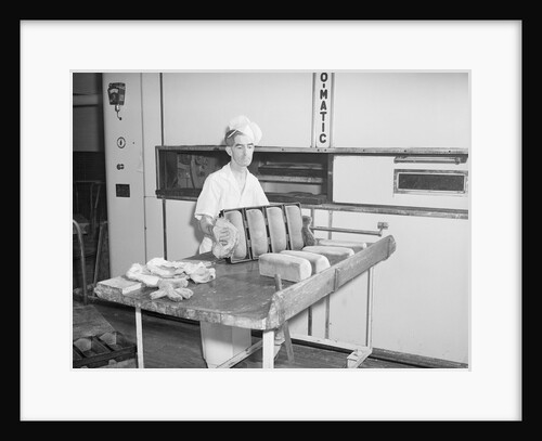 Man Taking Bread Loaves from Oven by Anonymous