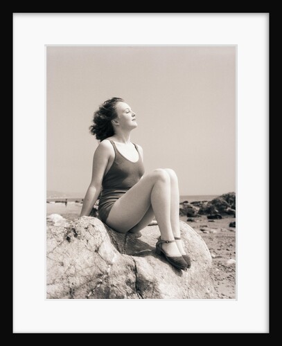 Young Woman Sitting on Beach Rocks by Anonymous