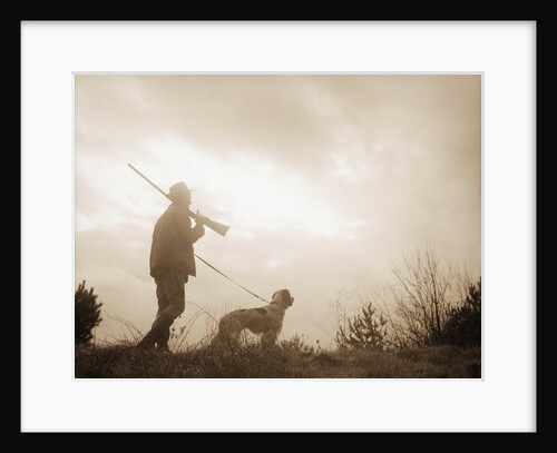 Silhouette of Hunter with Bird Dog Under Clouds by Anonymous