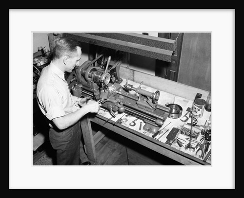 Man Working with Lathe in Basement Workshop by Anonymous