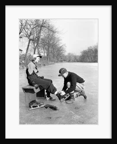 Man Putting on Woman's Ice Skates by Anonymous