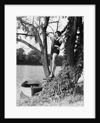 Woman Standing in Tree by Lake by Anonymous