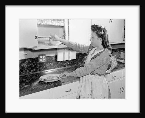 Woman Putting Dishes In Cabinet by Anonymous