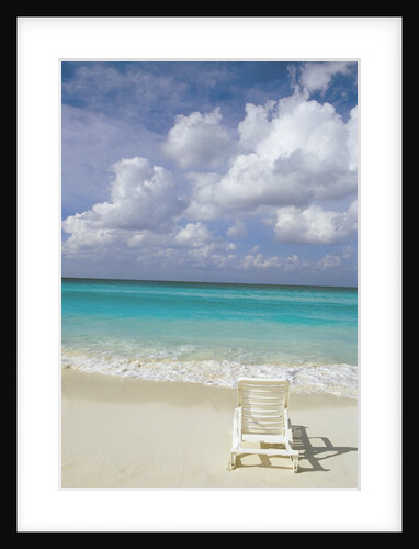 Lone Lounge Chair on Sandy Beach by Anonymous