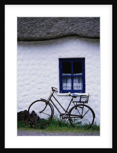 Bicycle Leaning Against a Thatch-Roof Cottage by Anonymous