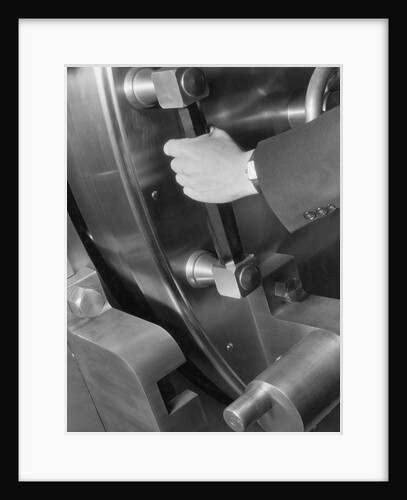 A Man Closes A Large Bank Vault by Anonymous
