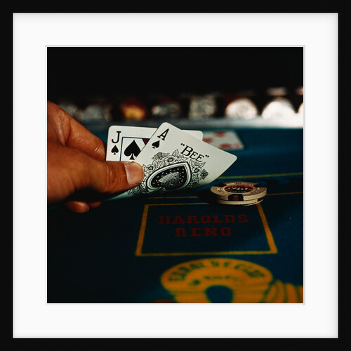 Hand Holding an Ace and Jack of Spades Cards by Anonymous