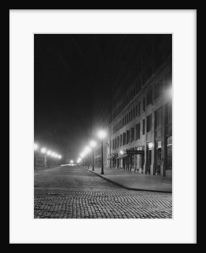 Street Lights Along a Cobblestone Street by Anonymous