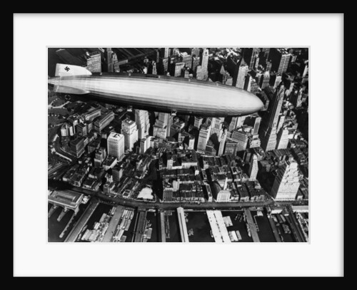 The German airship, the Hindenburg, above Manhattan, New York in 1936, on its way to its berth at Lakehurst , New Jersey, the same place where it inexplicably burst into flames the next year. by Anonymous