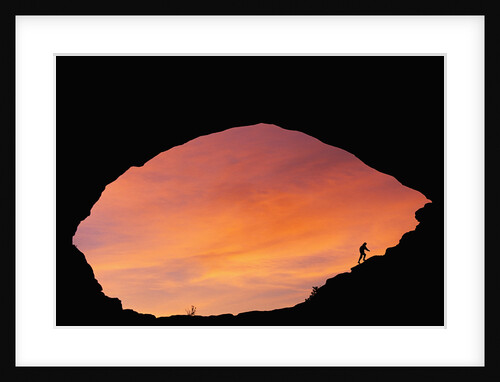 Hiker Climbing a Natural Arch in Utah by Anonymous