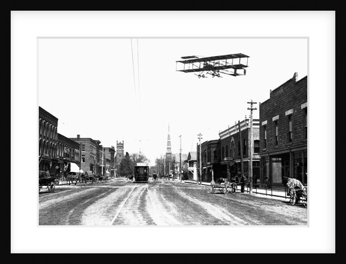 Biplane Over a Small Town by Anonymous