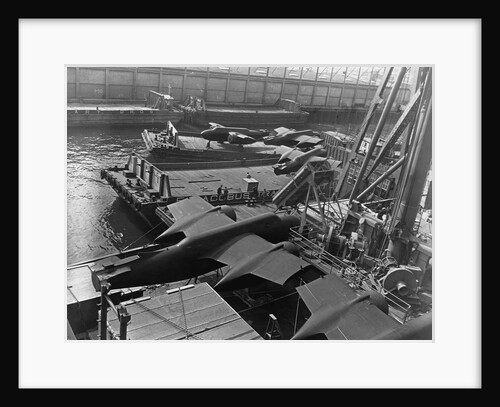Heavy bombers on barges awaiting loading onto cargo vessel in New York harbor for shipment under provisions of the lend-lease by Anonymous