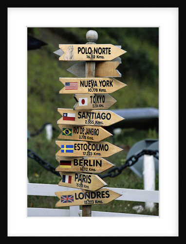 Mileage Sign Pointing Directions in Puerto Williams by Anonymous