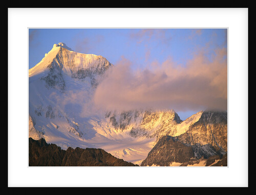 Cloud Floating by Glacier Covered Mountain Peak by Anonymous