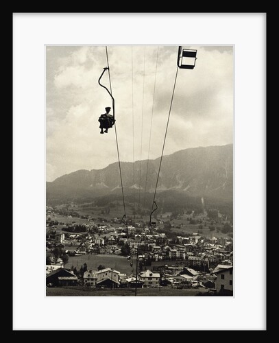 Man Riding Chair Lift Above Town by Anonymous