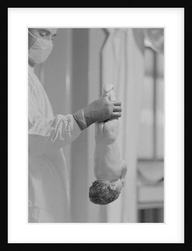Doctor Holds New Born Baby by his Feet by Anonymous