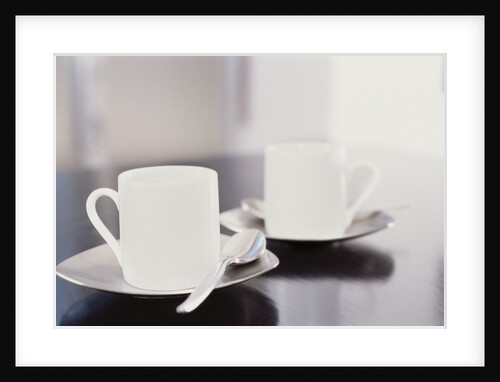 Two coffee cups on a table by Anonymous