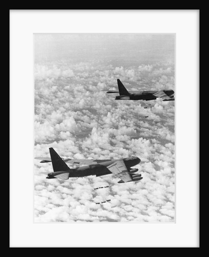 Military Airplane Dropping Bombs in Vietnam by Anonymous