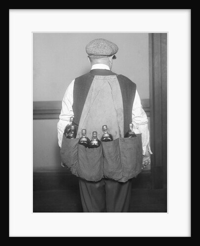Man Wearing Coat Holding Bottles by Anonymous
