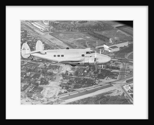 Howard Hughes Lockheed 14 Super Electra over Worlds Fair Site by Anonymous