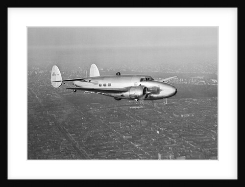 Howard Hughes' Lockheed 14 Super Electra over New York City by Anonymous