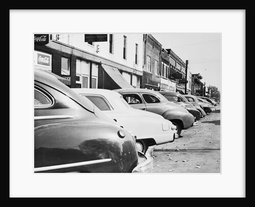 View of Parked Cars Along Street by Anonymous