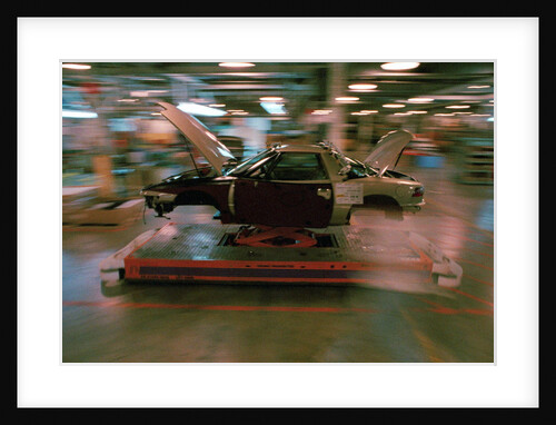 Partially Assembled Car Moving Through Work Station by Anonymous