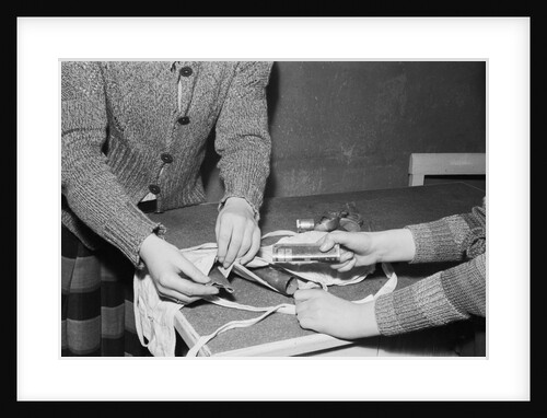 Women Placing Metal Scraps Into a Brassiere by Anonymous