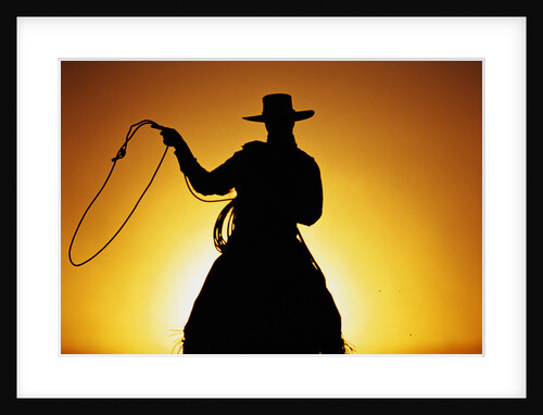 Silhouette of Cowboy on Horse Holding Rope by Anonymous