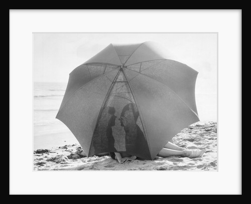 Couple on Beach Under Umbrella by Anonymous